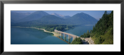 High Angle View Of A Bridge Across A Lake, Sylvenstein Lake, Bavaria, Germany by Panoramic Images Pricing Limited Edition Print image