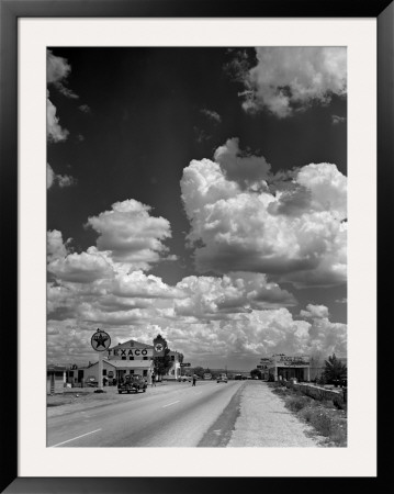 Cumulus Clouds Billowing Over Texaco Gas Station Along A Stretch Of Highway Us 66 by Andreas Feininger Pricing Limited Edition Print image