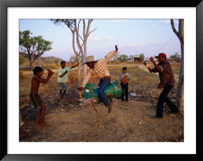 Boys Practising Rodeo Skills On 44 Gallon Drum, Kimberley, Western Australia, Australia by Richard I'anson Pricing Limited Edition Print image