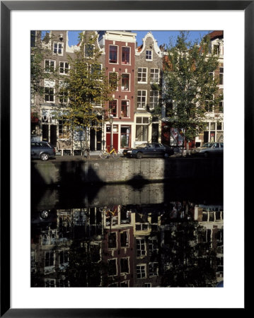Tall Traditional Style Houses Reflected In The Water Of A Canal, Amsterdam, The Netherlands by Richard Nebesky Pricing Limited Edition Print image