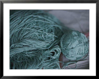A Ball Of Green Silk Yarn Lies Near A Pile Of Unwound Yarn by Jodi Cobb Pricing Limited Edition Print image
