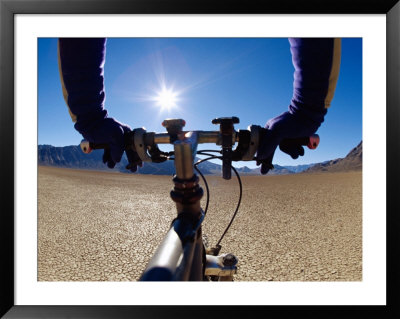 A Man Cycling Across A Desert Landscape by Barry Tessman Pricing Limited Edition Print image