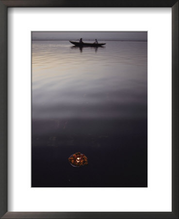 A Flower Offering Floats Past A Boat On The Ganges by George F. Mobley Pricing Limited Edition Print image