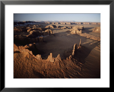 Ancient Sandstone Spires Rise From Monument Valley by Paul Chesley Pricing Limited Edition Print image