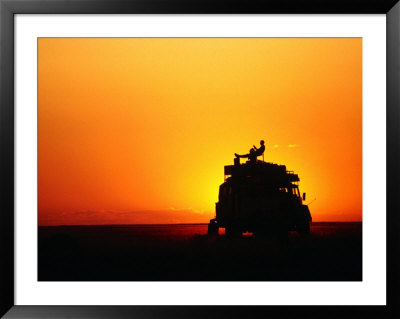 Tourist Watching Sunset On Roof Of Safari Vehicle, Central Kalahari Game Reserve, Botswana by David Wall Pricing Limited Edition Print image