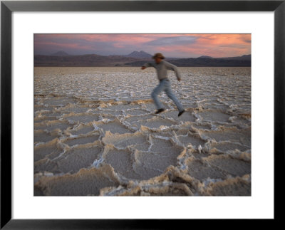 A Man Runs Across The Surface Of Salar De Atacama Salt Flat by Joel Sartore Pricing Limited Edition Print image