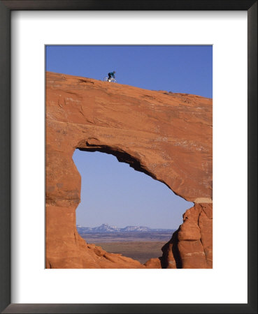 Cyclist On Natural Arch by Bill Hatcher Pricing Limited Edition Print image