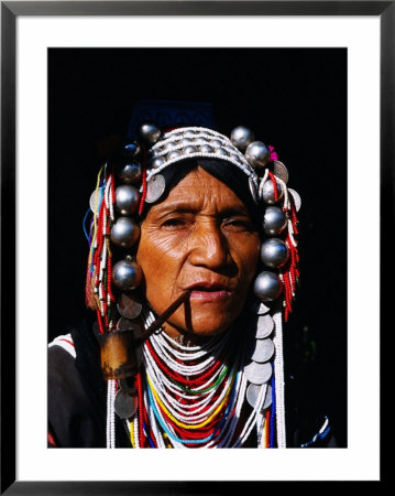 Akha Woman Smoking Pipe In Northern Thailand, Thailand by Juliet Coombe Pricing Limited Edition Print image