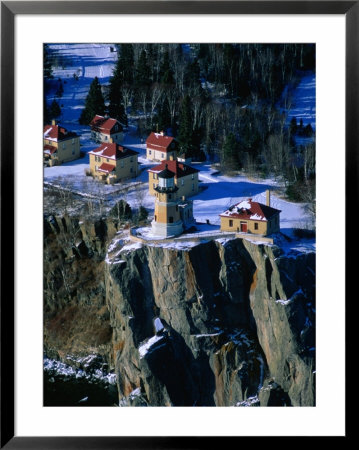 Lighthouse And Houses Under Blanket Of Snow On Top Of Cliff At Split Rock, Minnesota, Usa by Jim Wark Pricing Limited Edition Print image