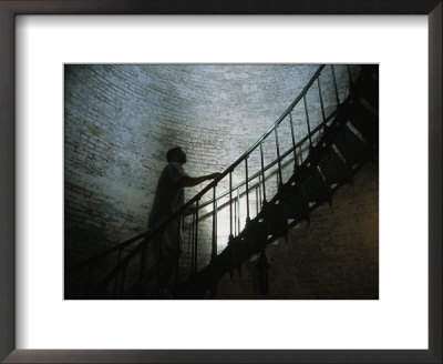 Man Climbs The Staircase Inside The Currituck Beach Lighthouse by Stephen Alvarez Pricing Limited Edition Print image