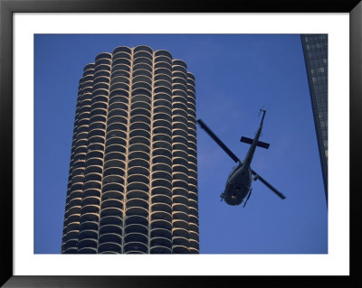 A Helicopter Flies Between Skyscrapers by Joel Sartore Pricing Limited Edition Print image