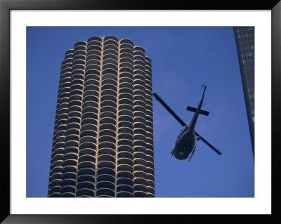 A Helicopter Flies Between Skyscrapers by Joel Sartore Pricing Limited Edition Print image
