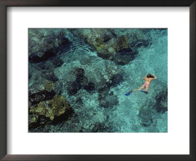 In Shimmering Waters, A Snorkeler Explores Boulder-Strewn Shallows by Ira Block Pricing Limited Edition Print image