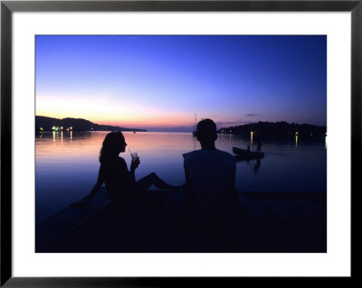Silhouetted Couple At Dusk At Huntress Marina, Port Antonio, Jamaica by Holger Leue Pricing Limited Edition Print image
