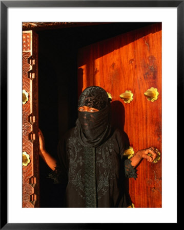 Woman In Bui-Bui Standing In Zanzibar Doorway, Looking At Camera, Lamu, Kenya by Ariadne Van Zandbergen Pricing Limited Edition Print image