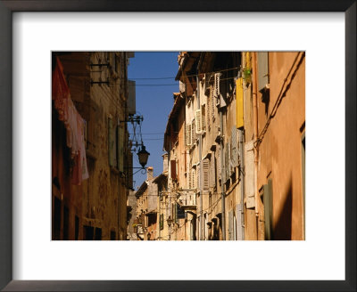 Building Facades In Winding Cobbled Street Of Fishing Town, Rovinj, Croatia by Jon Davison Pricing Limited Edition Print image