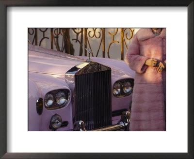 A Woman Wearing A Pink Mink Coat Stands Next To A Pink Rolls Royce by Jodi Cobb Pricing Limited Edition Print image