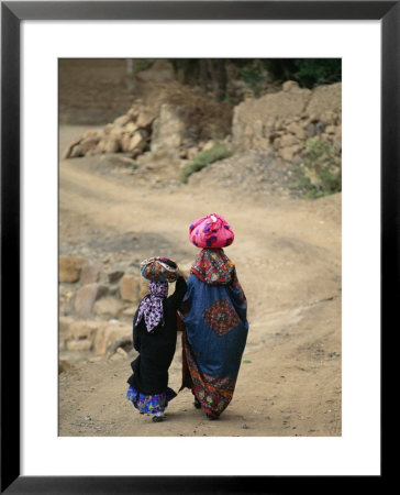 A Yemeni Woman And Child Carrying Bundles On Their Heads by Michael Melford Pricing Limited Edition Print image