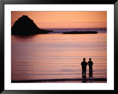 Two People Silhouetted In Sunset Over Sea, Sunset Bay State Park, Usa by Ryan Fox Pricing Limited Edition Print image