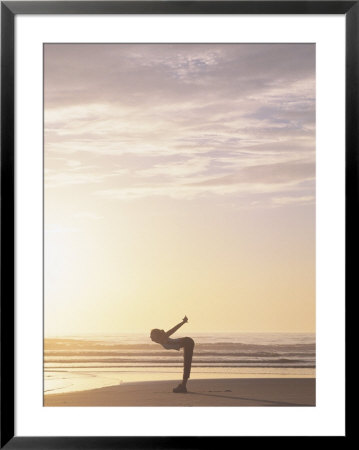 Woman Stretching On Beach At Sunrise by Kevin Radford Pricing Limited Edition Print image
