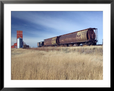 Grain Elevators And Wheat Train, Saskatchewan, Canada by Walter Bibikow Pricing Limited Edition Print image