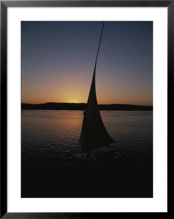 Sunset Outlines The Curve Of A Felucca Sail On The Nile River by Stephen St. John Pricing Limited Edition Print image