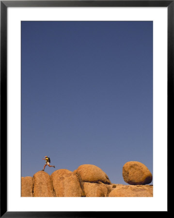 Hiker Jumping On Rocks by Bill Hatcher Pricing Limited Edition Print image