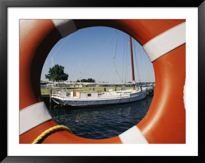 An Orange Life Preserver Frames A Sailboat At The Museum by Stephen St. John Pricing Limited Edition Print image