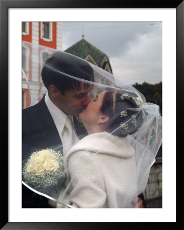 The Groom Kisses His Bride In Front Of The Church Of The Resurrection by Richard Nowitz Pricing Limited Edition Print image