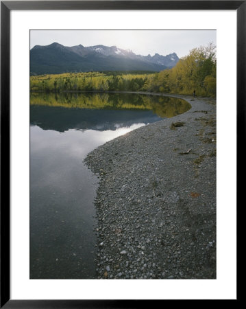Mountains Cast Reflections Into Clear Water Along A Pebbly Shore by Bill Curtsinger Pricing Limited Edition Print image