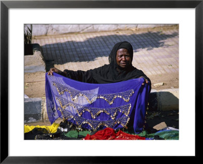 A Nubian Woman Sells Colorful Scarves On The Street by Stephen St. John Pricing Limited Edition Print image
