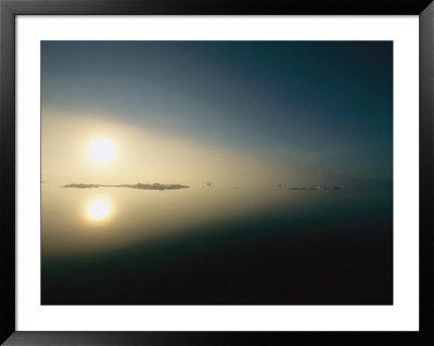 A Rising Sun Casts Its Reflection Upon The Arctic Ocean by Norbert Rosing Pricing Limited Edition Print image