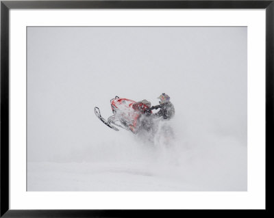 A Snowmobiler Jumps From A Hill On A Snowy Day by Taylor S. Kennedy Pricing Limited Edition Print image