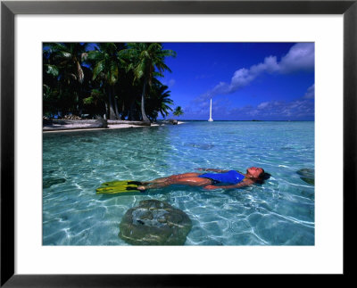 Woman In Blue Bathers Floating On Back In Tropical Water, French Polynesia by Michael Aw Pricing Limited Edition Print image