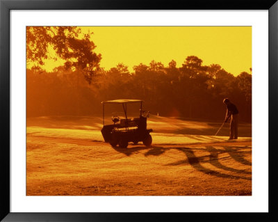 Man And Golf Cart Silhouetted At Sunset by Bill Bachmann Pricing Limited Edition Print image