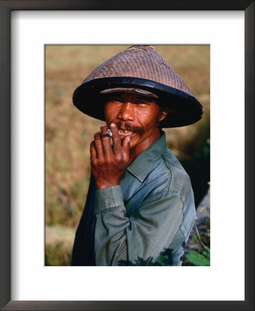Portrait Of A Farm Worker Smoking A Cigarette, Looking At Camera, Ubud, Indonesia by Kraig Lieb Pricing Limited Edition Print image