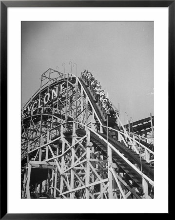 Thrill Seekers At The Top Of The Cyclone Roller Coaster At Coney Island Amusement Park by Marie Hansen Pricing Limited Edition Print image