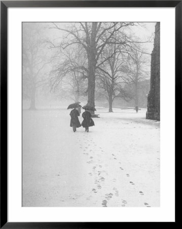 Snow Falling While People Take A Stroll Across Campus Of Winchester College by Cornell Capa Pricing Limited Edition Print image