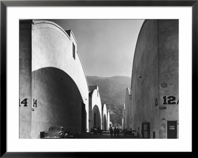 People Walking Between Sound Stages At Warner Brothers Studio by Margaret Bourke-White Pricing Limited Edition Print image