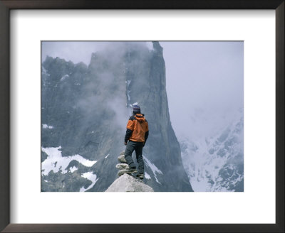 A Man Stands On A Cliff Watching A Snowstorm In Charakusa Valley by Jimmy Chin Pricing Limited Edition Print image