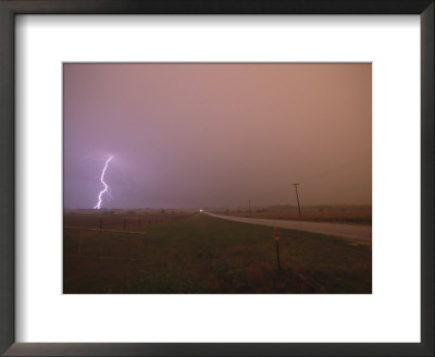 Cloud-To-Ground Lightning Strikes A Field And Brightens A Foggy Sky by Peter Carsten Pricing Limited Edition Print image