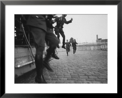 West Berlin Police Officers Jump From Truck As Two Others Come Running To Start Guard Duty by Paul Schutzer Pricing Limited Edition Print image