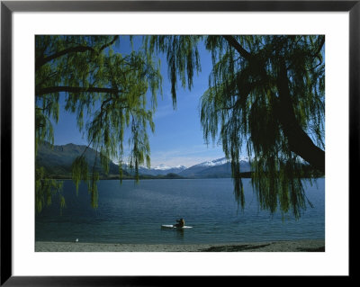 Lone Kayaker On A Lake With Snow-Capped Mountains In Background by Todd Gipstein Pricing Limited Edition Print image