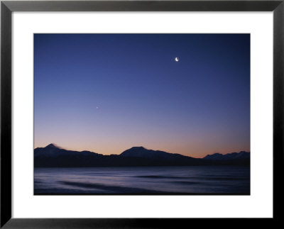 The Moon Rises Along With A Planet Over Mountain Ridges At Twilight by Norbert Rosing Pricing Limited Edition Print image