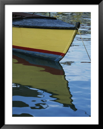 The Bow Of An Anchored, Striped Boat Is Reflected On The Water by Michael Melford Pricing Limited Edition Print image