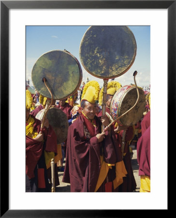 Yellow Hat Tibetan Buddhist Monks Playing Drums At Festival, Naqu (Nagchu) (Nakchu), Tibet, China by Maurice Joseph Pricing Limited Edition Print image