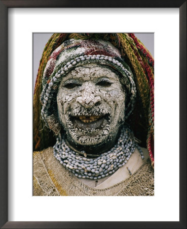Face Caked With Clay, A Margarima Tribesman Smiles For The Camera by Jodi Cobb Pricing Limited Edition Print image