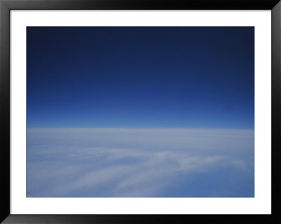 A View Of A Blanket Of Clouds Taken From Inside An Airplane by Raul Touzon Pricing Limited Edition Print image