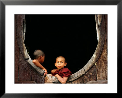 Two Young Novice Monks At Monastery Window, Myanmar by Anthony Plummer Pricing Limited Edition Print image