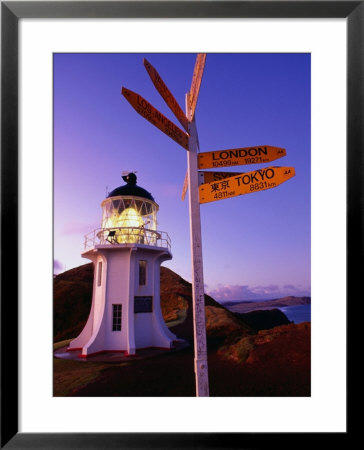 Signpost In Front Of Lighthouse At Dawn, Cape Reinga, New Zealand by Oliver Strewe Pricing Limited Edition Print image